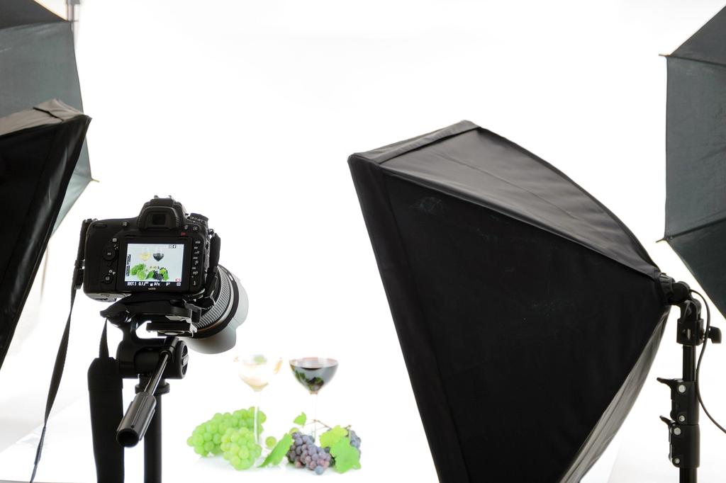 Photographer setting up lighting for a product shoot